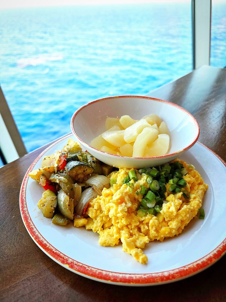 scrambled eggs, grilled vegetables, and pears