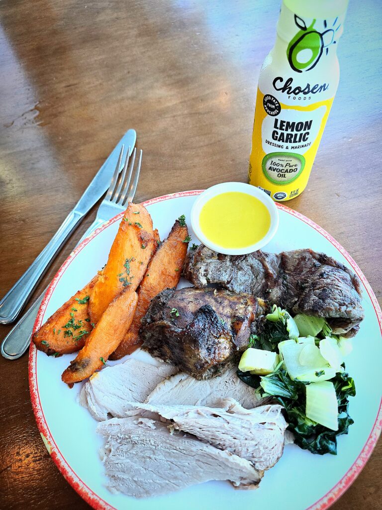 Caribbean dinner with jerk pork, jerk chicken, New York strip steak, sweet potatoes, and bok choy