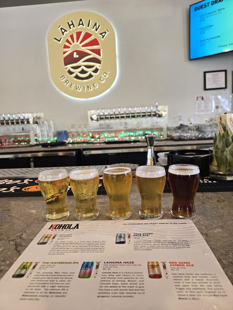 kohola series beer flight with lahaina sign in the background